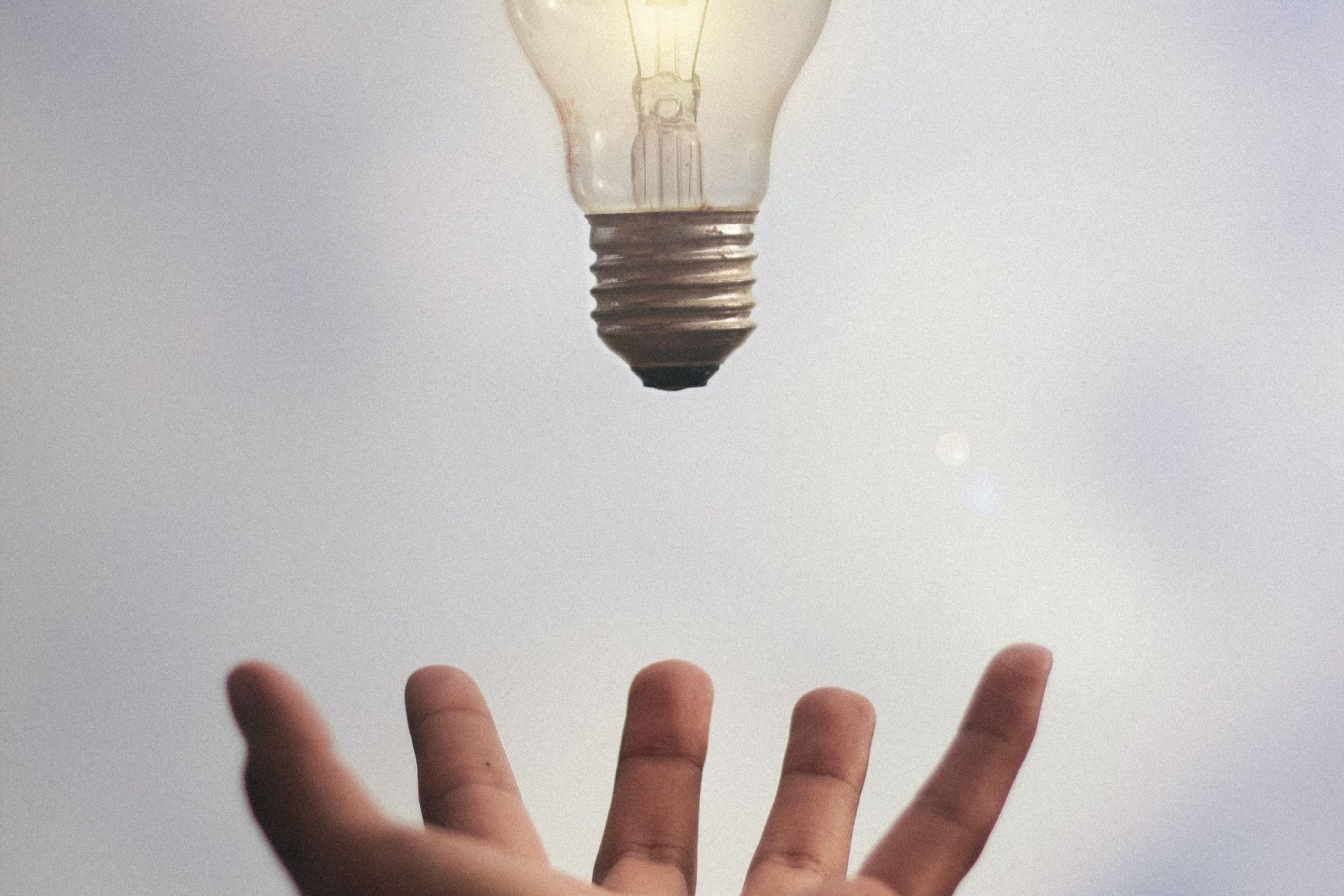 Hand grasping for a light bulb