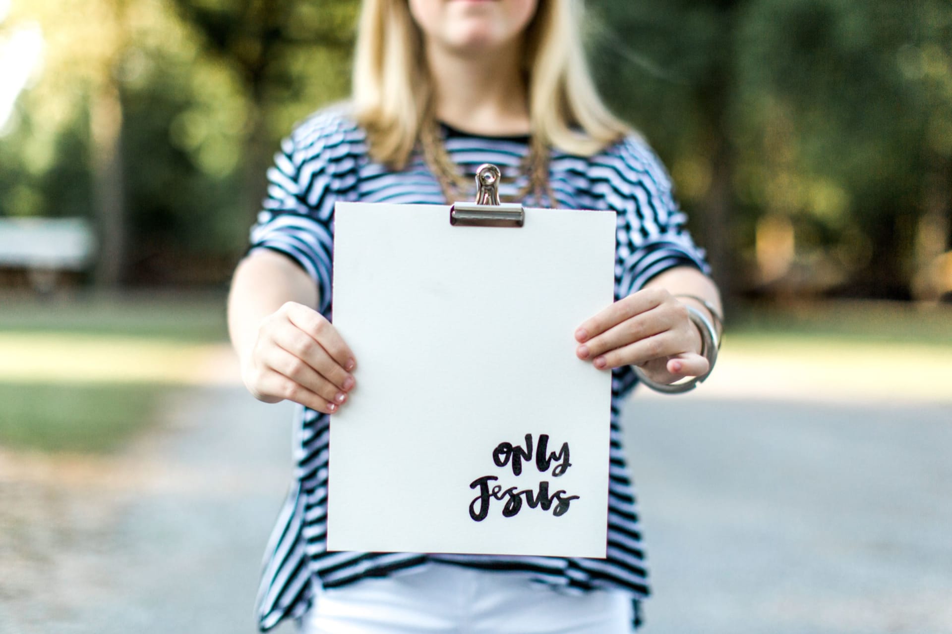 Woman with board saying 